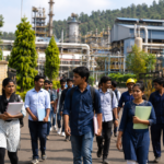 Students walking toward industrial campus entrance
